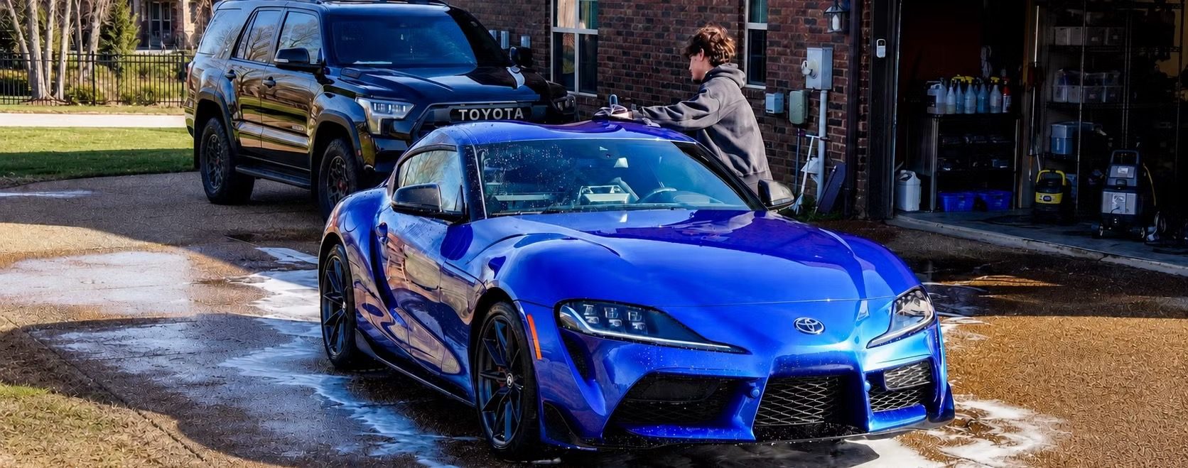 Superior Suds detailing a blue Toyota Supra in a customer’s driveway
